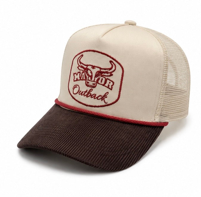 A trucker-style baseball cap with an off-white front panel and mesh back, featuring a dark brown corduroy brim and a red embroidered 'Major Outback' bull logo on the front.