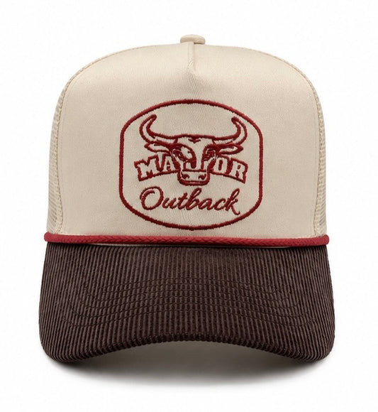A trucker-style baseball cap with an off-white front panel and dark brown mesh back, featuring a brown corduroy brim. The front panel has an embroidered logo of a bull head inside an oval with the text 'MAJOR Outback' in brown.
