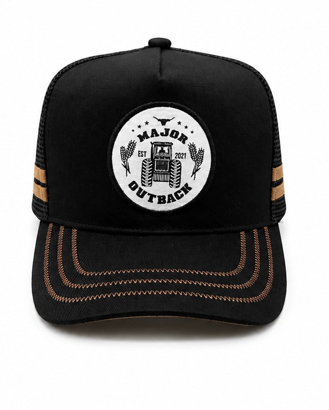 A black trucker-style baseball cap with a white circular front patch reading 'MAJOR OUTBACK EST 2021' around a tractor graphic, plus tan contrast stitching on the brim and side stripes, shown on a white background.